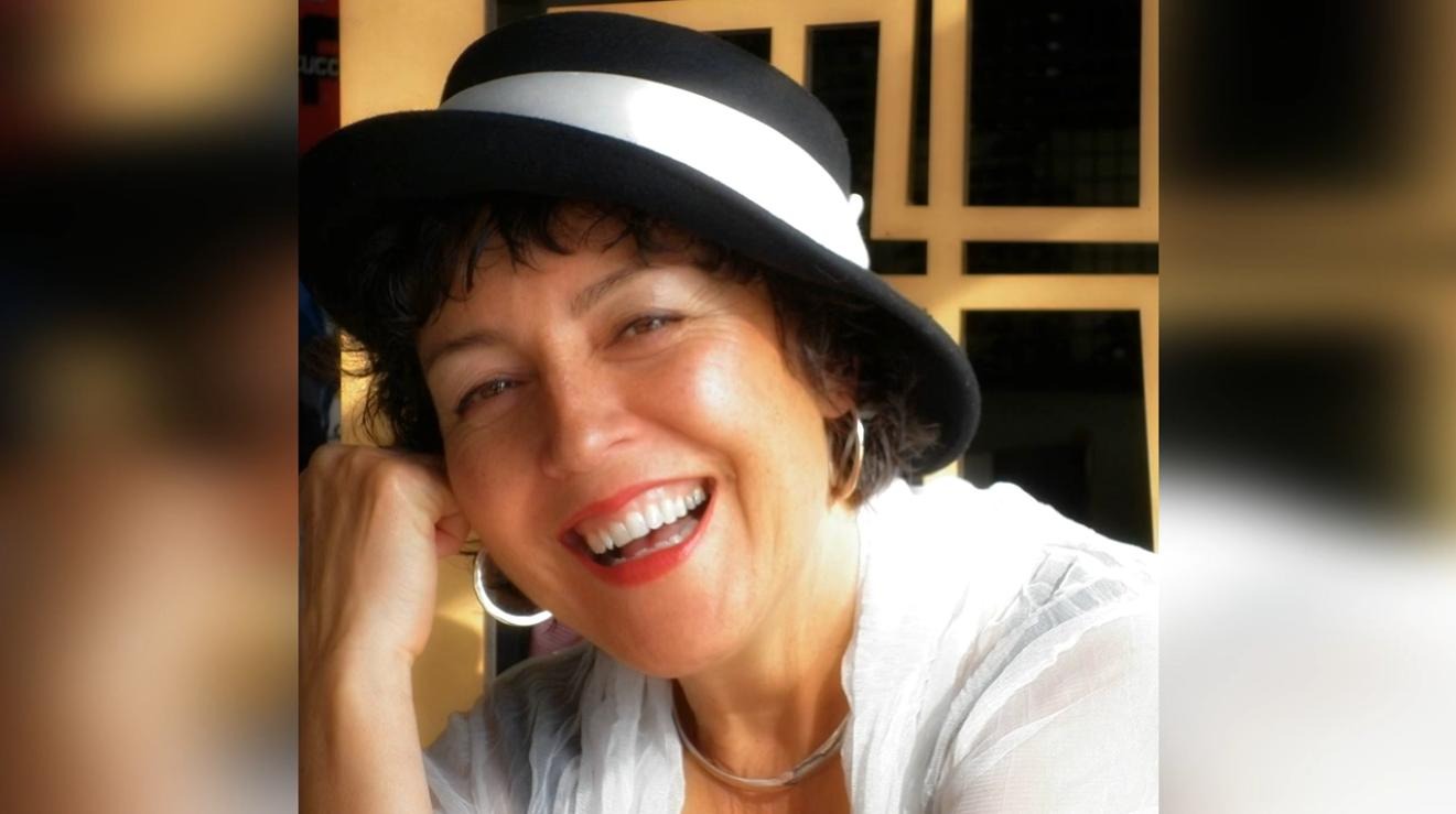 Ruby Page smiling in a black hat