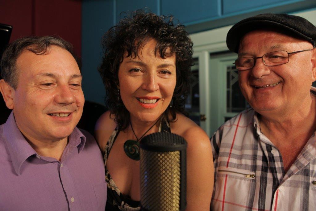 Joe Ruberto, Ruby Page and Bob Venier gathered around a microphone